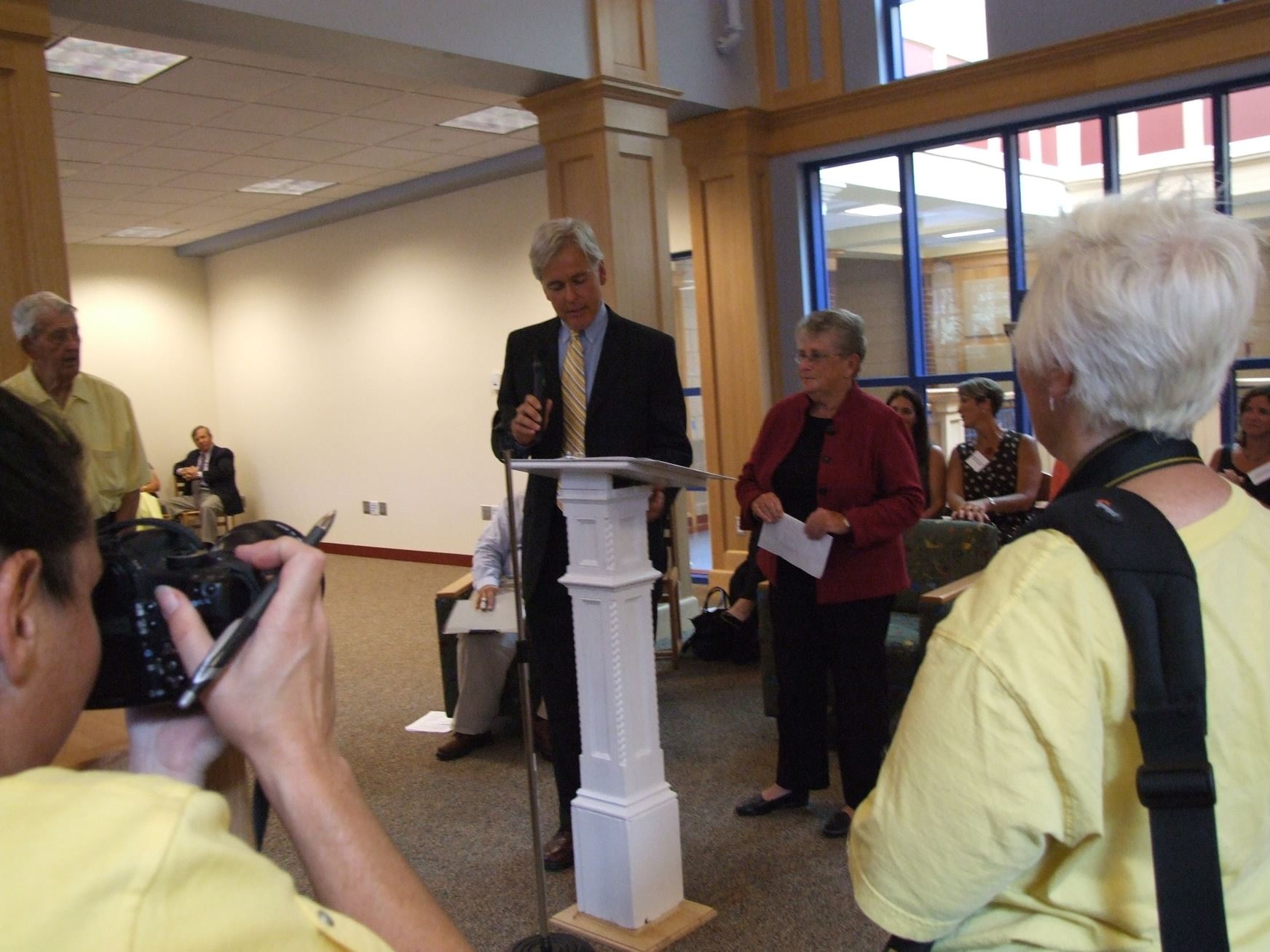 Man Reading from Podium